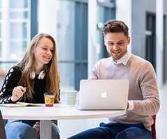 UCD students on a laptop.